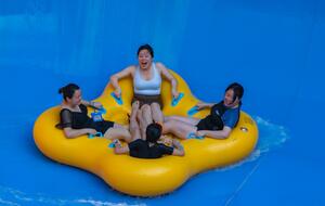People riding a water slide in China
